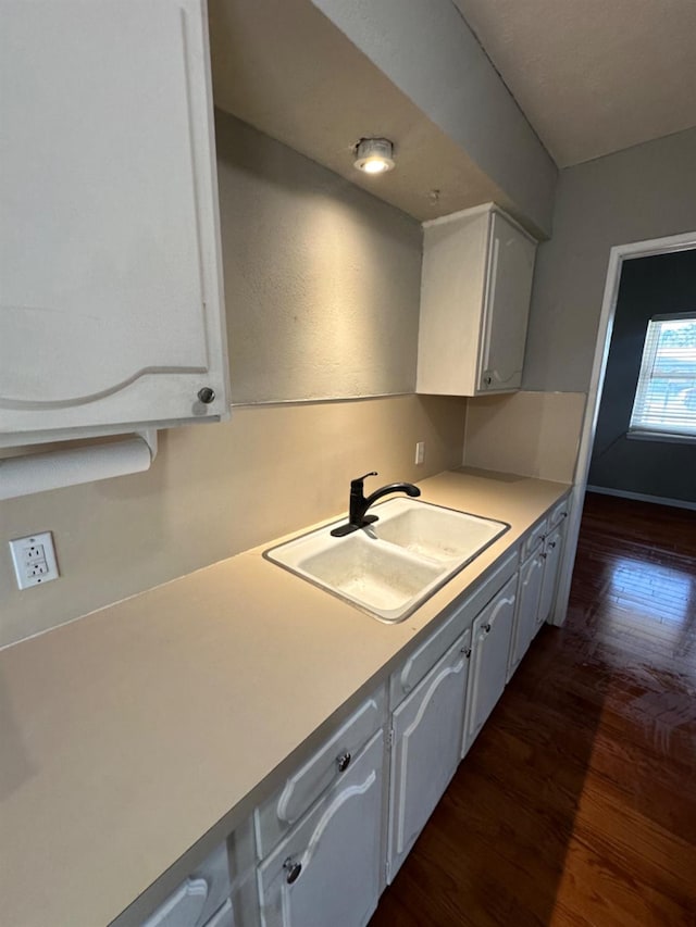 kitchen featuring sink, white cabinets, and dark hardwood / wood-style floors