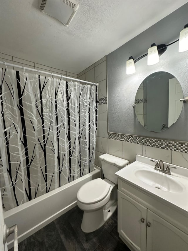 full bathroom featuring toilet, a textured ceiling, tile walls, vanity, and hardwood / wood-style floors