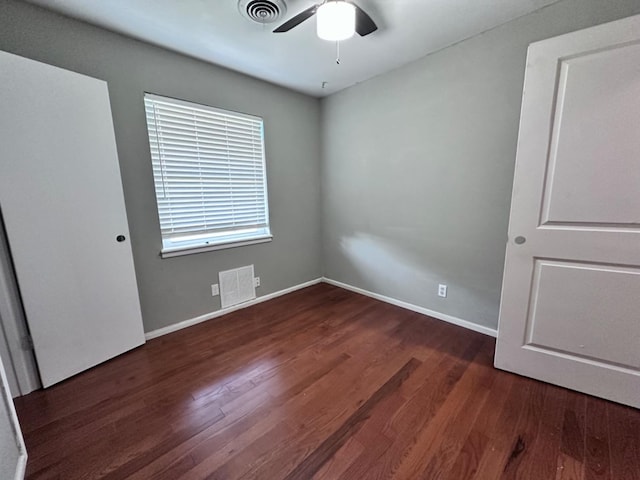 spare room with ceiling fan and dark hardwood / wood-style flooring