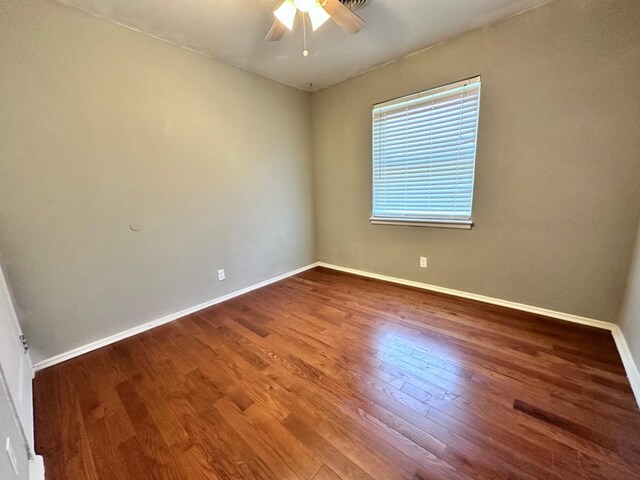 empty room featuring hardwood / wood-style flooring and ceiling fan