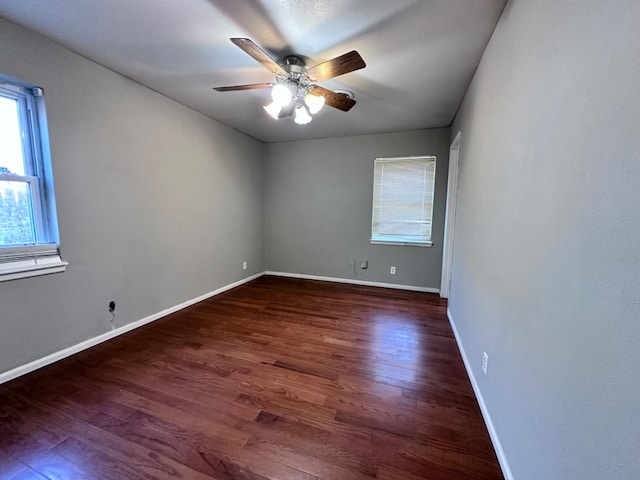 unfurnished room with dark hardwood / wood-style flooring and ceiling fan