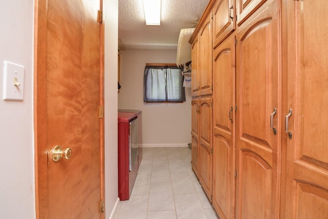 2911 US Highway 385, Littlefield, TX 79339 - interior space with washing machine and dryer, a textured ceiling, and light tile patterned floors