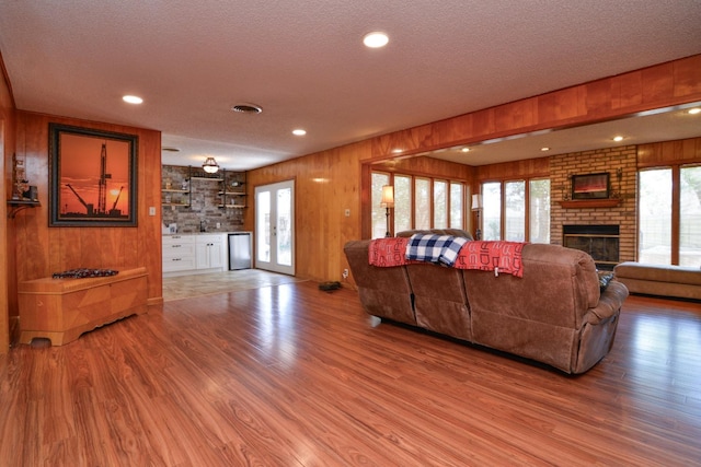 2911 US Highway 385, Littlefield, TX 79339 - living room with wood-type flooring, wooden walls, and a textured ceiling