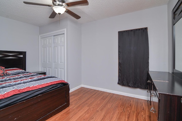2911 US Highway 385, Littlefield, TX 79339 - bedroom featuring ceiling fan, a textured ceiling, light hardwood / wood-style floors, and a closet