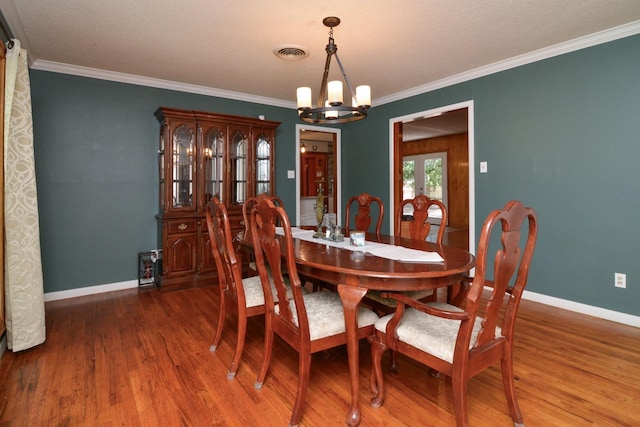 2911 US Highway 385, Littlefield, TX 79339 - dining space featuring french doors, ornamental molding, dark hardwood / wood-style floors, and a chandelier