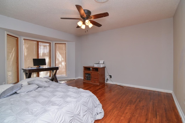 2911 US Highway 385, Littlefield, TX 79339 - bedroom featuring ceiling fan, wood-type flooring, and a textured ceiling