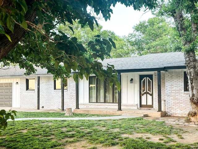 2911 US Highway 385, Littlefield, TX 79339 - view of front of property with a garage and a front yard
