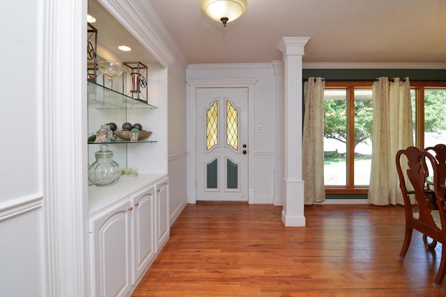2911 US Highway 385, Littlefield, TX 79339 - foyer featuring decorative columns, ornamental molding, and hardwood / wood-style flooring