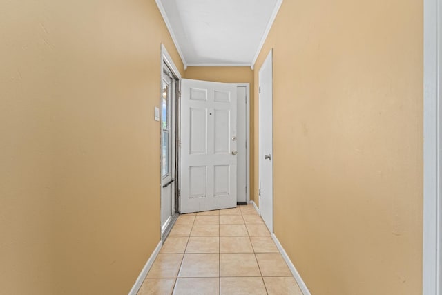 hall featuring crown molding and light tile patterned floors