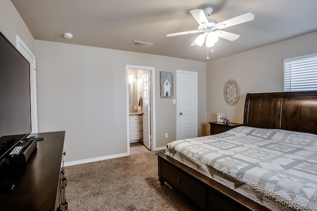 carpeted bedroom with ceiling fan and ensuite bathroom