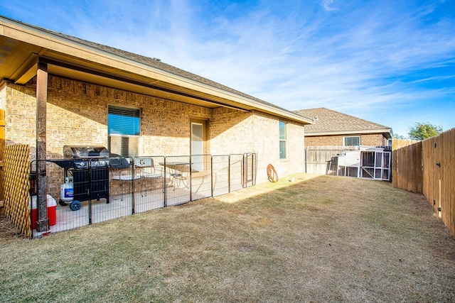 rear view of house featuring a yard