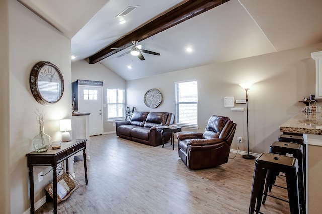 living room with ceiling fan, light wood-type flooring, and vaulted ceiling with beams