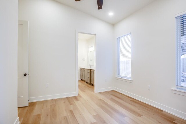 3628 119th St, Lubbock, TX 79423 - unfurnished bedroom featuring light wood-style floors, multiple windows, and ensuite bathroom