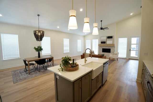 3628 119th St, Lubbock, TX 79423 - kitchen with a fireplace, dishwasher, a ceiling fan, light wood-style floors, and light countertops