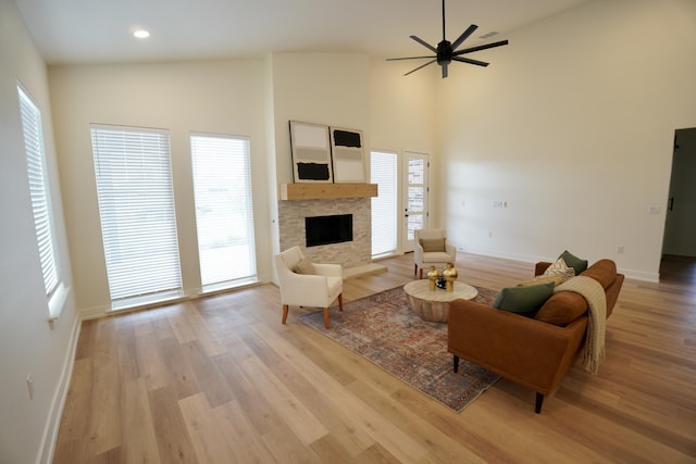 3628 119th St, Lubbock, TX 79423 - living room featuring a fireplace, healthy amount of natural light, light wood-style floors, recessed lighting, and a high ceiling