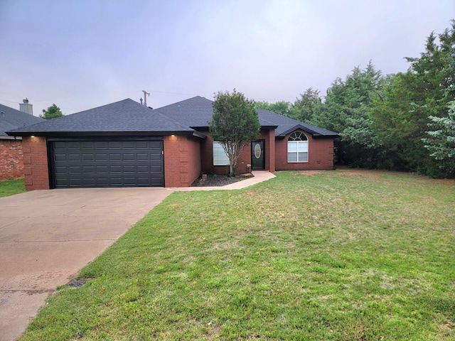 single story home featuring a garage and a front lawn