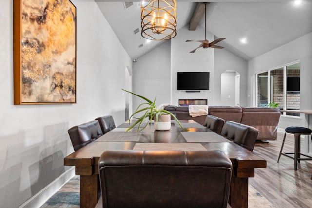 dining room with high vaulted ceiling, light hardwood / wood-style floors, beamed ceiling, and ceiling fan