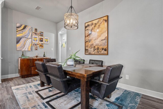 living room featuring ceiling fan with notable chandelier, high vaulted ceiling, beamed ceiling, and light wood-type flooring