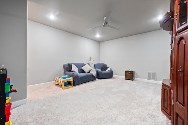 game room featuring light colored carpet and ceiling fan