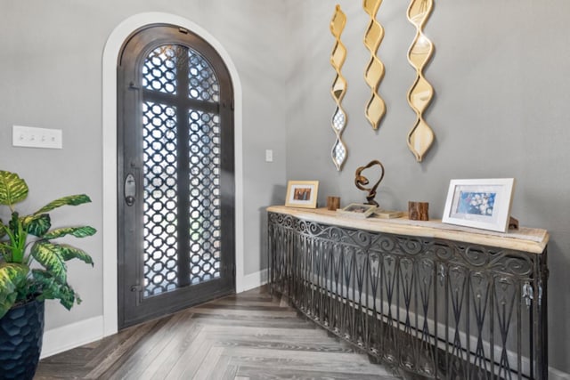 entryway featuring parquet floors, french doors, and a healthy amount of sunlight