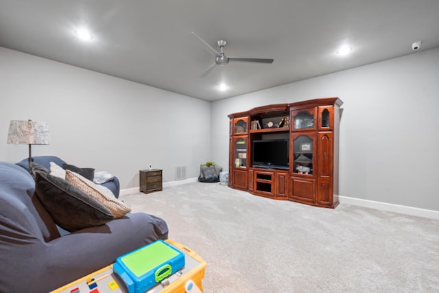 living room with ceiling fan and carpet flooring