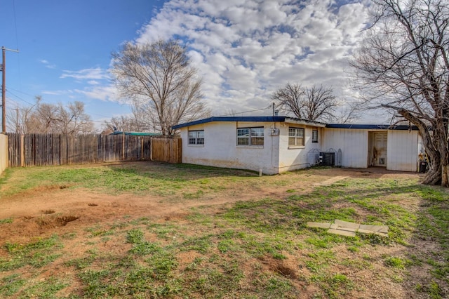 exterior space with central AC and a yard