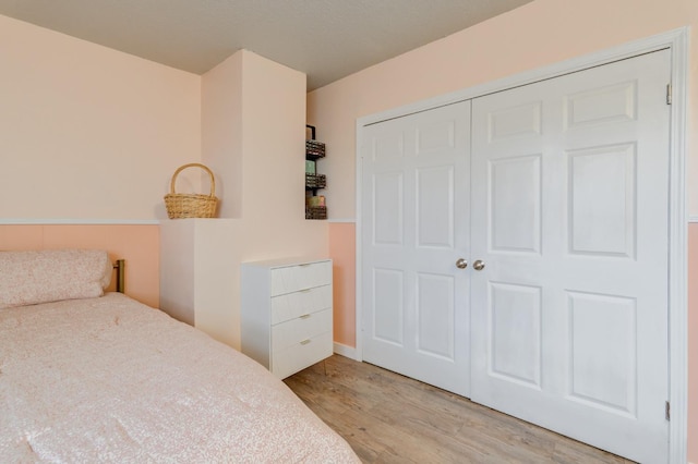 bedroom featuring light hardwood / wood-style floors and a closet