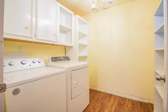 washroom featuring cabinets, washing machine and dryer, and dark hardwood / wood-style floors