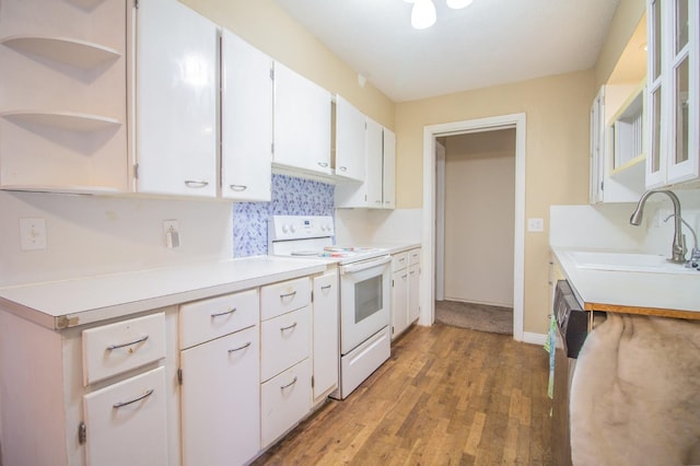 kitchen with white range with electric stovetop, tasteful backsplash, sink, white cabinets, and hardwood / wood-style flooring