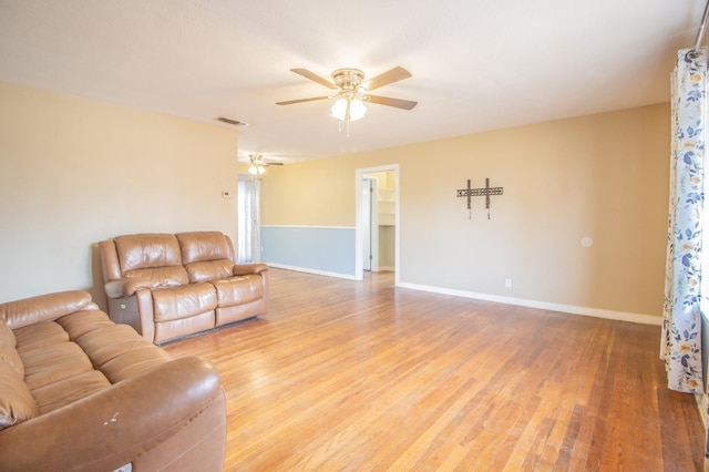 living room featuring hardwood / wood-style floors and ceiling fan