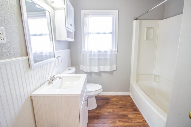 full bathroom featuring shower / bathtub combination, vanity, toilet, and hardwood / wood-style floors