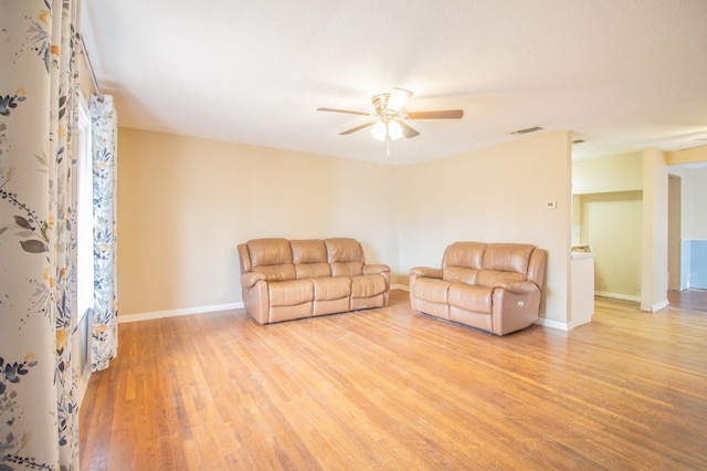 living room with ceiling fan and light hardwood / wood-style flooring