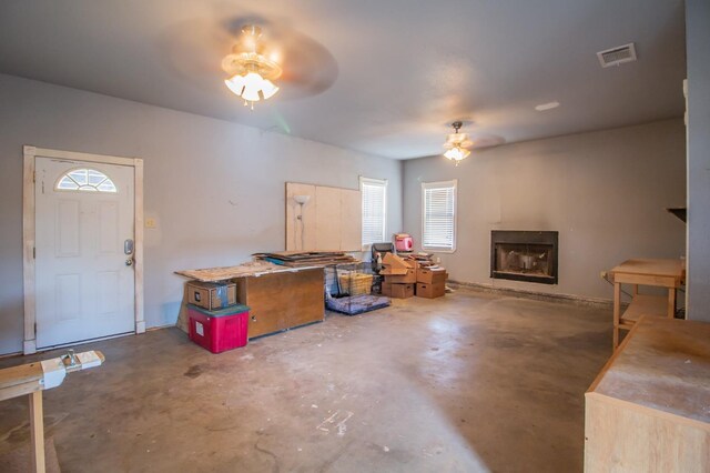 interior space with ceiling fan