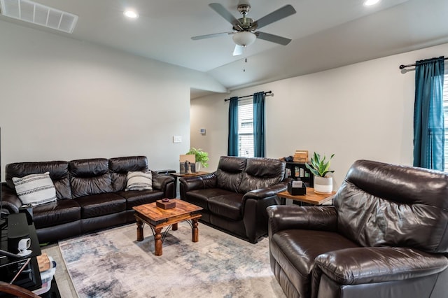 living room with ceiling fan and vaulted ceiling