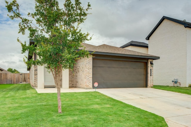 view of front of house featuring a garage and a front lawn