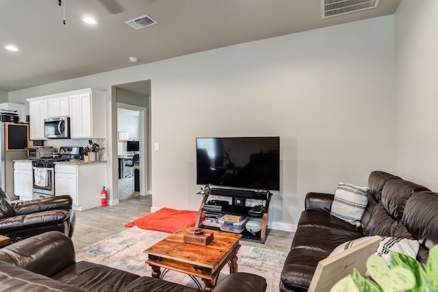 living room with light hardwood / wood-style flooring