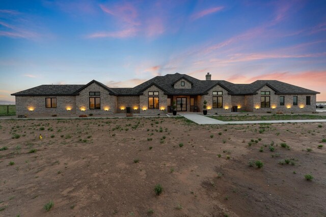 french country inspired facade featuring a patio area