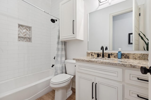 full bathroom featuring vanity, wood-type flooring, shower / bath combination with curtain, and toilet