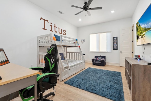 bedroom with light hardwood / wood-style flooring and ceiling fan