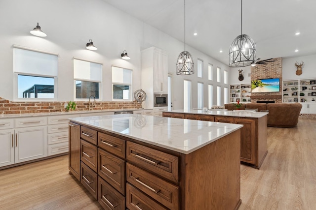 kitchen featuring white cabinetry, pendant lighting, a center island, and appliances with stainless steel finishes