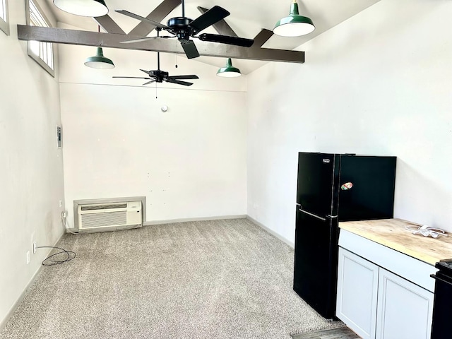 interior space featuring black fridge, white cabinetry, vaulted ceiling, light carpet, and a wall unit AC