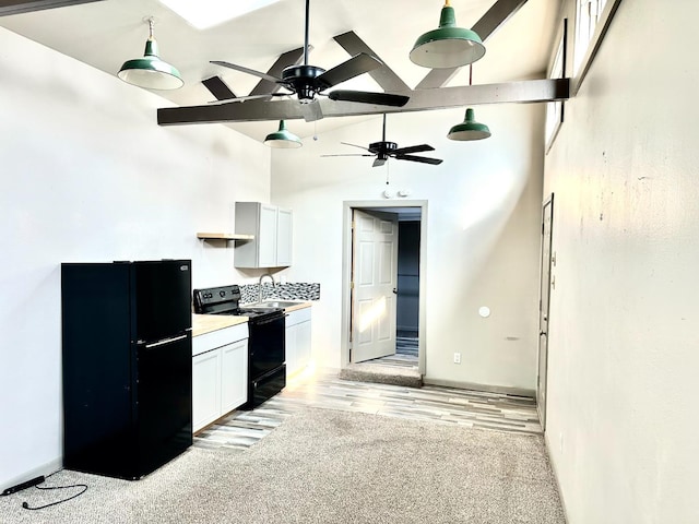 kitchen with white cabinetry, high vaulted ceiling, light hardwood / wood-style flooring, and black appliances