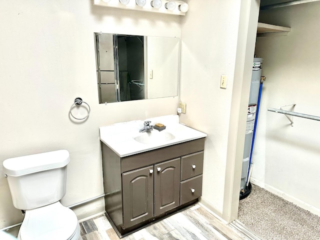 bathroom with vanity, hardwood / wood-style flooring, and toilet