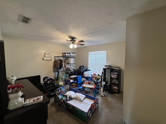 interior space with visible vents, a textured ceiling, and a ceiling fan