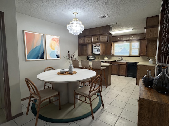 5013 57th St, Lubbock, TX 79414 - dining room featuring a textured ceiling, a chandelier, and light tile patterned floors