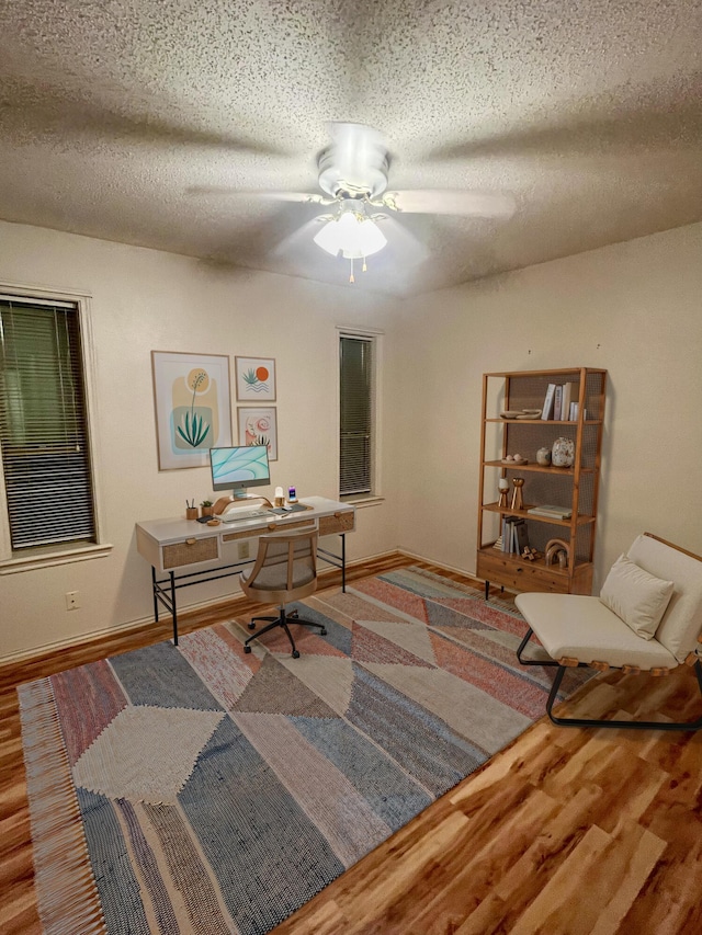 5013 57th St, Lubbock, TX 79414 - office featuring wood finished floors, ceiling fan, and a textured ceiling