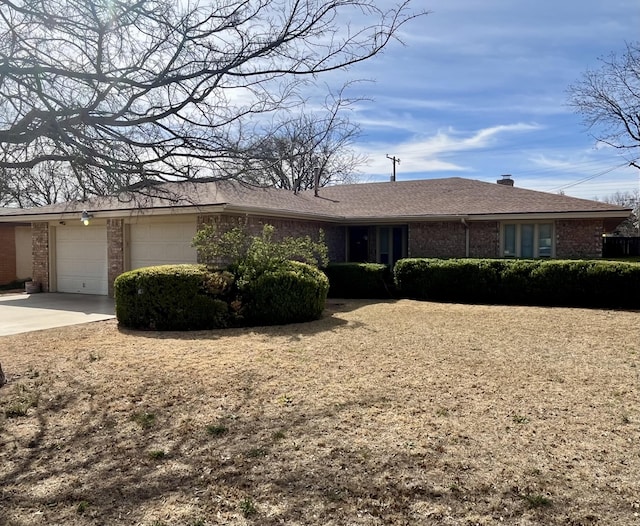 5013 57th St, Lubbock, TX 79414 - ranch-style home featuring brick siding, a garage, and concrete driveway