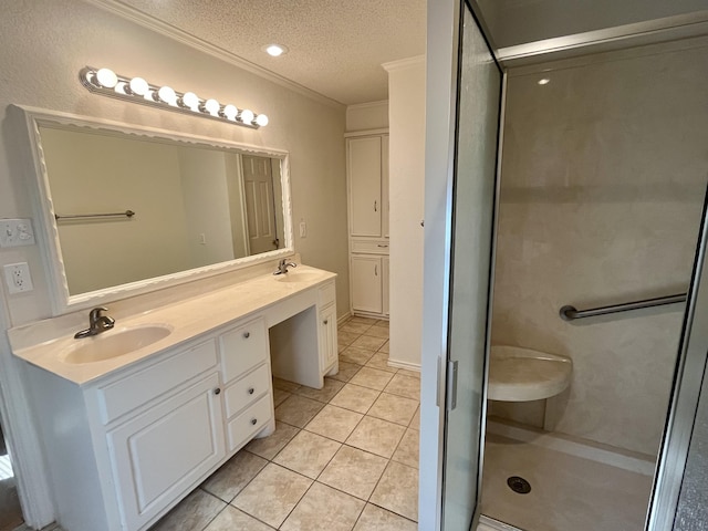 5013 57th St, Lubbock, TX 79414 - bathroom with a textured ceiling, double vanity, tile patterned floors, crown molding, and a shower stall
