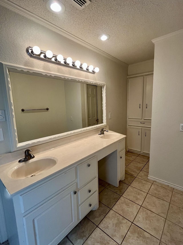 5013 57th St, Lubbock, TX 79414 - bathroom with crown molding, double vanity, tile patterned flooring, and a textured ceiling