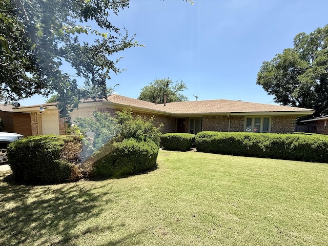 5013 57th St, Lubbock, TX 79414 - ranch-style home with an attached garage, a front lawn, and brick siding